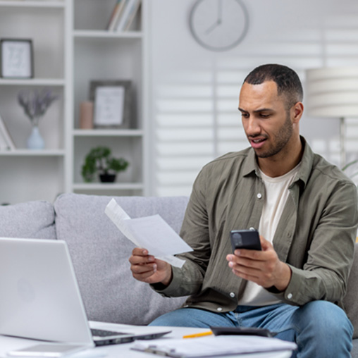 Patient looking up their dental insurance while budgeting