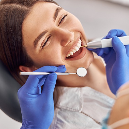 a patient smiling during her dental treatment